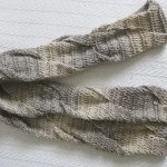 Crochet scarf with twist pattern and subtle color changes in the brown/gray family