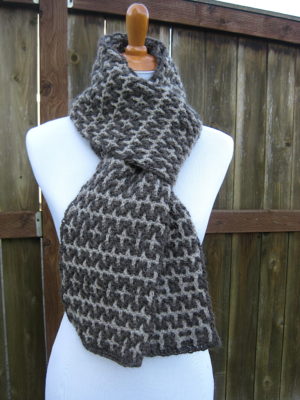 Light and dark gray intermeshing crochet scarf on mannequin