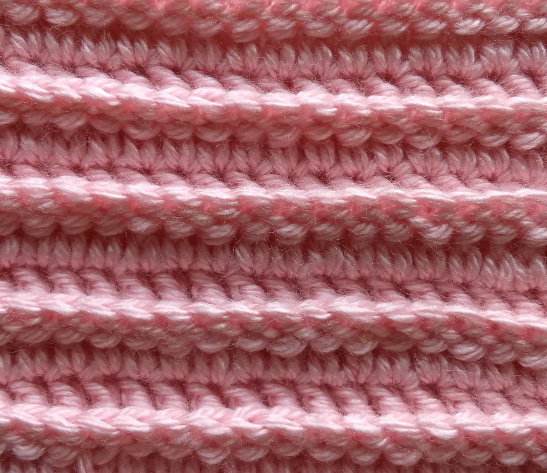 Pink crocheted square with ridges formed using back post crochet