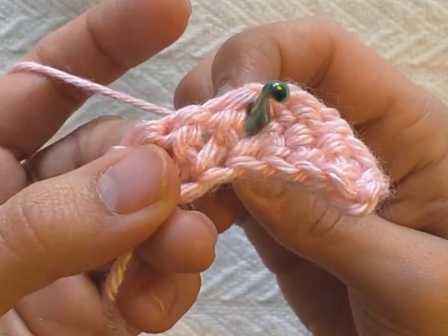 insert hook from back to front at the right of the post of the previous row's stitch.