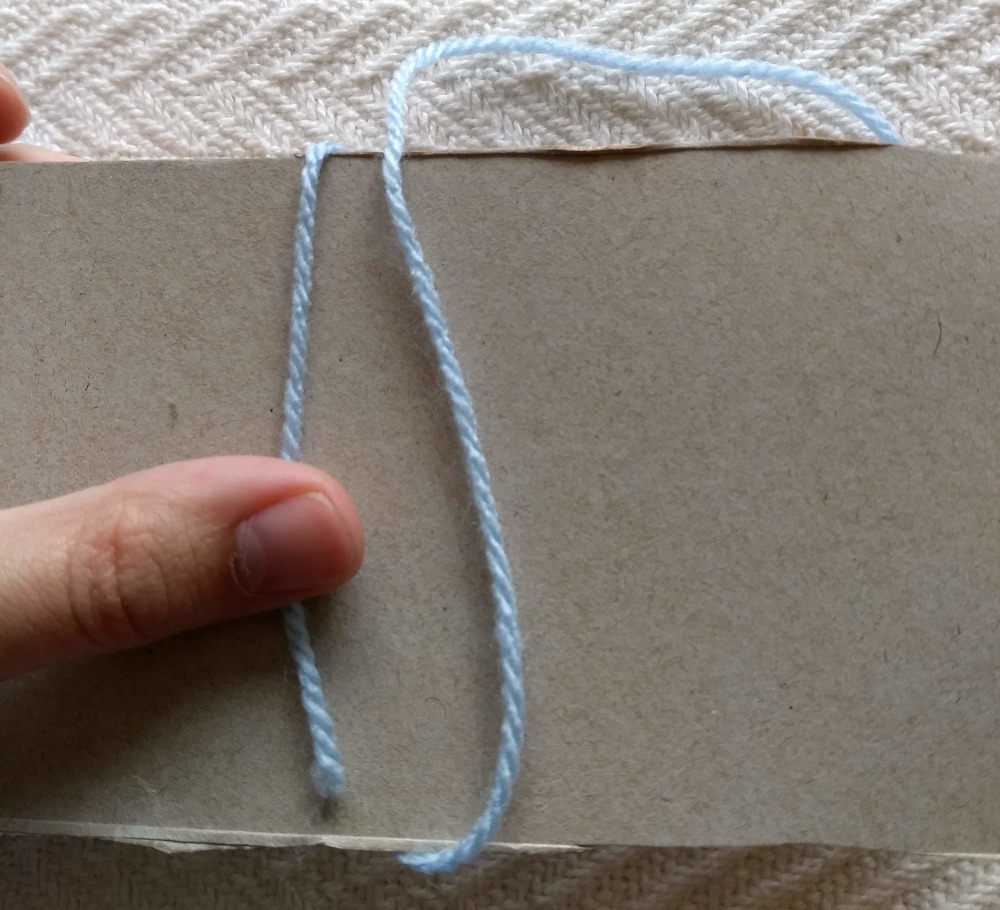 Hold an end against the cardboard and start wrapping