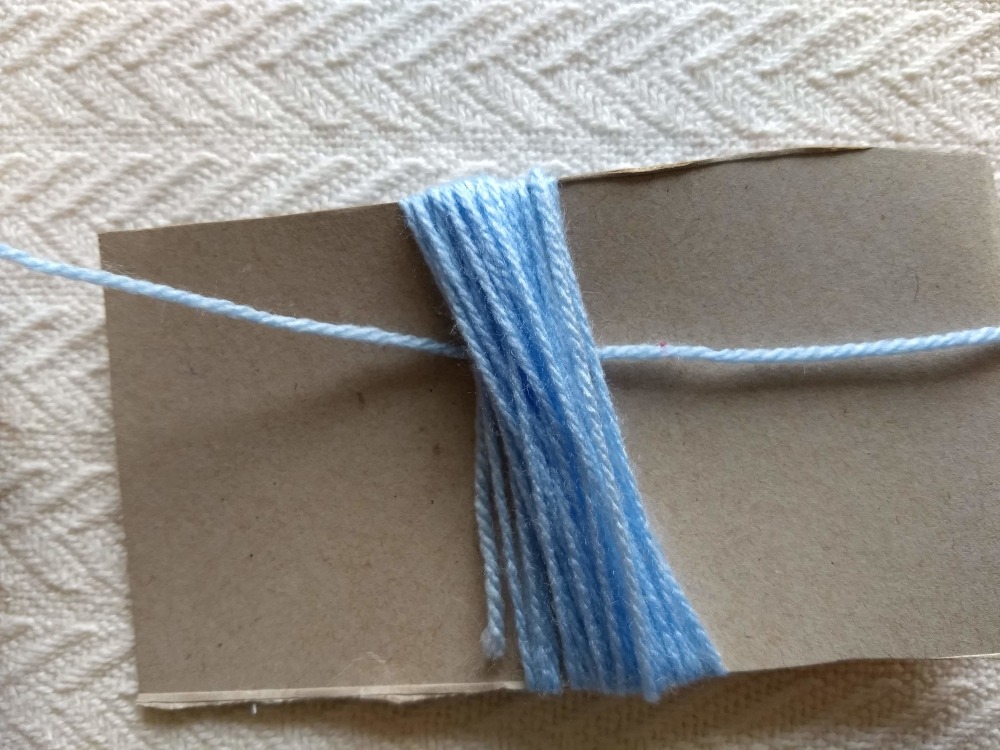 slide a strand of yarn under your yarn wraps