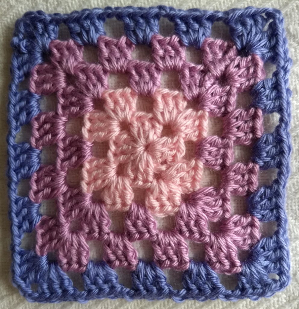 A pink and Purple Crocheted Granny Square