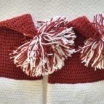 Two crocheted santa hats