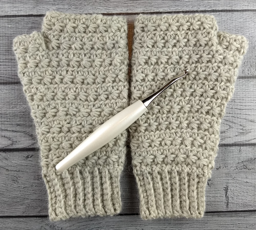 Gray Crocheted Fingerless Gloves with a White Furls Crochet Hook
