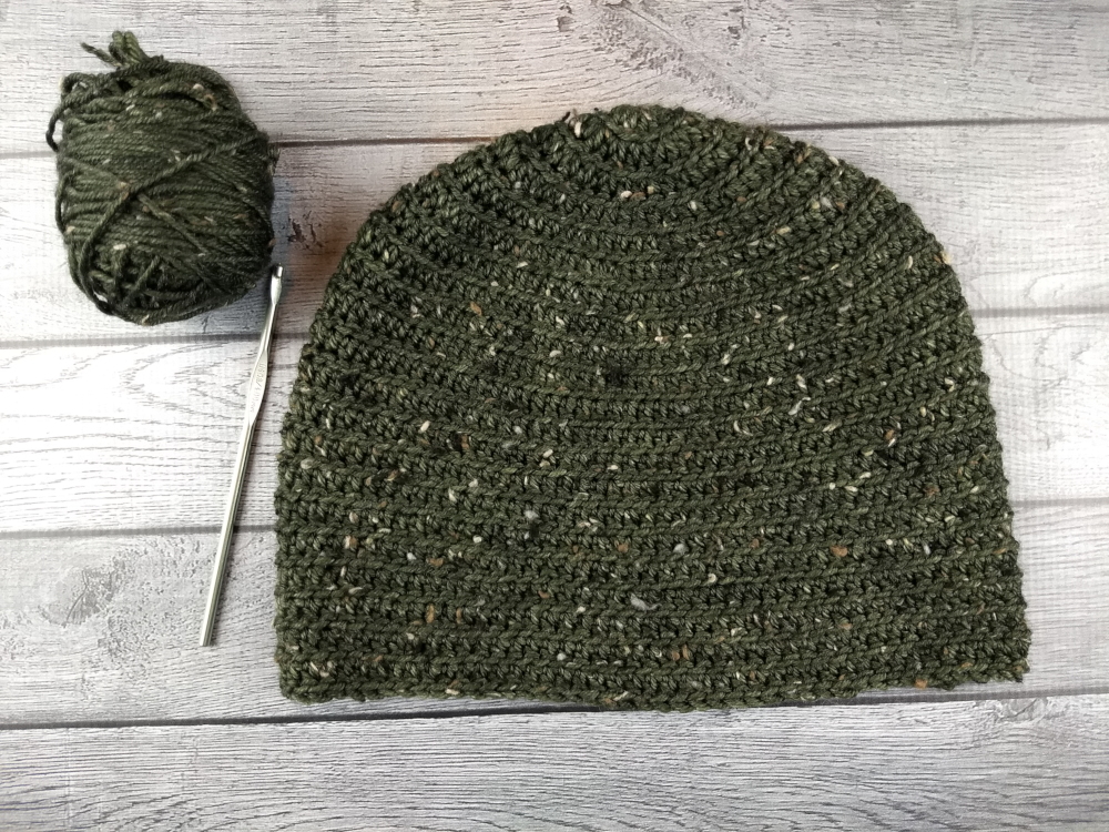 Green Crochet Beanie Hat with Yarn and Crochet Hook - Free pattern on blog