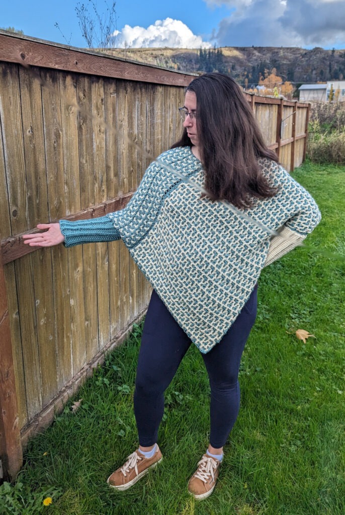 Green and white crochet poncho with sleeves, interlocking crochet